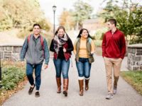 students walk around campus in fall
