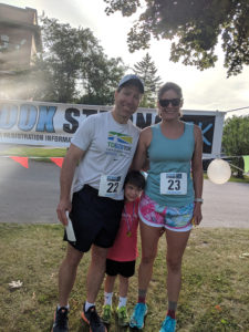 Faculty family fun: Dr. Steve Bridge and Camilla Bridge with first-time runner Gideon.