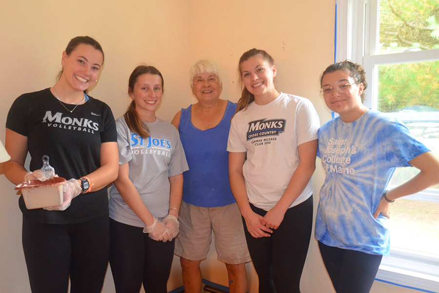 SJC volunteers Heather Darby, Annie Frey, Carly Jordan and Amela Opperman help Fuller Housing volunteer Caryl with morning painting at the Wilton’s house.