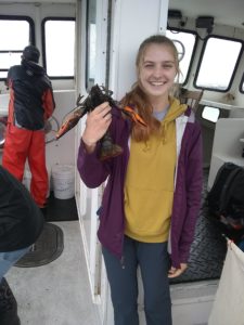 student holds lobster