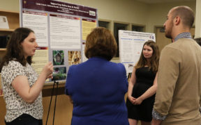 students and staff at academic research fair