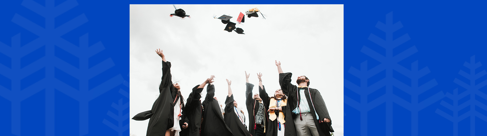 graduates toss caps in the air