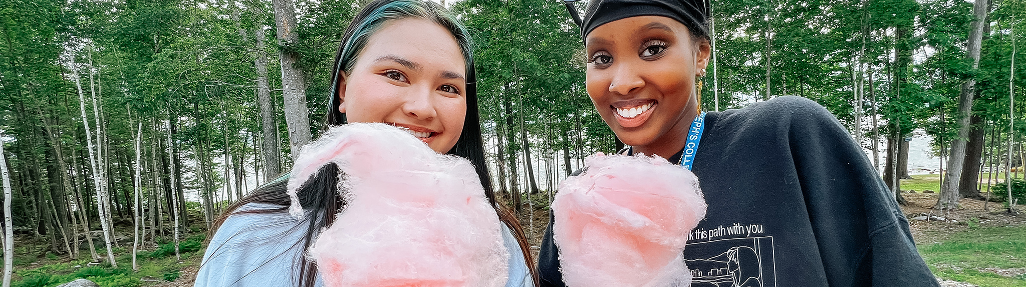 two new students enjoy cotton candy at a welcome to campus event